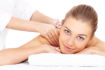 A portrait of a happy woman having a massage over white background